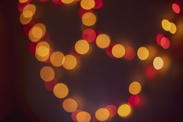 The background of the bokeh of the evening city. Festive Christmas New Year illuminations in city streets