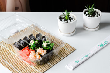 Fresh and delicious maki and nigiri sushi. sushi set in the plastic box. Delivery concept