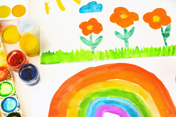 Children's drawing rainbow water color paints  on a paper