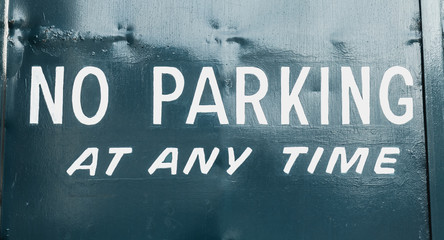 no parking at any time in white letter on a portal in the street