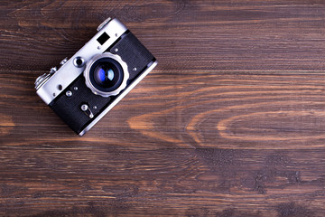 Vintage camera on wooden background,top view