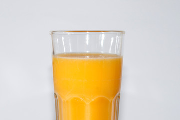 Orange juice glass, isolated on white background, closeup side view