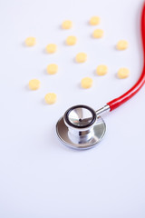 stethoscope for doctor checkup with pills on medical laboratory table