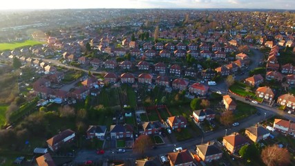 Aerial drone footage over a British council housing estate, UK houses and homes - Powered by Adobe