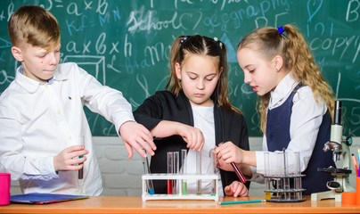 students doing biology experiments with microscope in lab. Little kids learning chemistry. Looking at the future of science. Chemistry education. Happy children. Chemistry lesson. Chemistry equipment