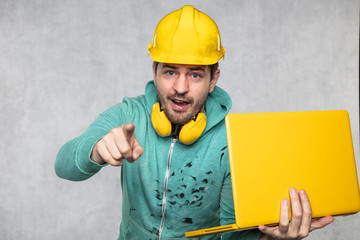 modern building supervisor keeps the computer in his hands, technology at work