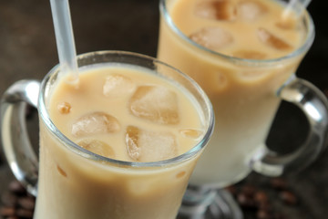 Ice latte or Iced coffee with milk and ice cubes in a glass beaker against a dark background. refreshing drink. summer drink.