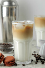 Ice latte or Iced coffee with milk and ice cubes in a glass beaker on a light background. refreshing drink. summer drink.