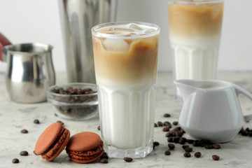 Ice latte or Iced coffee with milk and ice cubes in a glass beaker on a light background. refreshing drink. summer drink.
