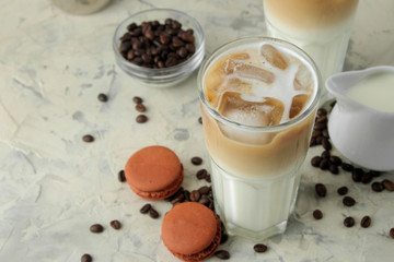 Ice latte or Iced coffee with milk and ice cubes in a glass beaker on a light background. refreshing drink. summer drink.