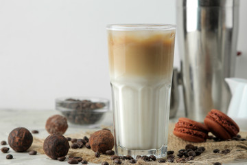 Ice latte or Iced coffee with milk and ice cubes in a glass beaker on a light background. refreshing drink. summer drink.