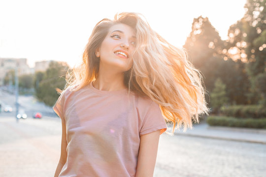 Beautiful Woman With Long Hair Walking On The Street