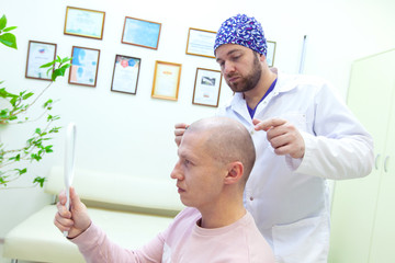 Baldness treatment. Patient suffering from hair loss in consultation with a doctor. Preparation for...