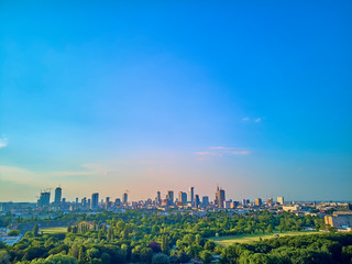 Fototapeta na wymiar A beautiful panoramic view of the sunset in a fabulous evening in June from drone at Pola Mokotowskie in Warsaw, Poland - 