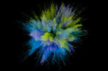 Colored powder explosion. Abstract closeup dust on backdrop. Colorful explode. Paint holi