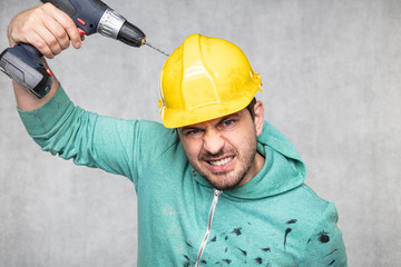 the construction worker holds an electric screwdriver in his hand, various situations