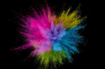 Colored powder explosion. Abstract closeup dust on backdrop. Colorful explode. Paint holi