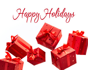 Gift box. Photos in fashionable style. Red gift boxes hang in air on white background. Happy Holidays.