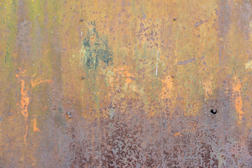 Old abandoned or dilapidated construction objects of brick and concrete on the outskirts of the city.Rusty metal gates and other structures.Texture of sand, soil, grass, stones and broken bricks.Press