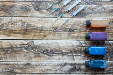 ink for printer syringes in wooden background