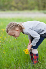 Young blond girl posing outdoors