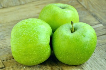 green apples on wooden background