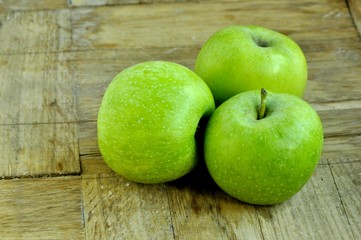 green apples on wooden background