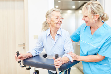 Physiotherapist and senior with rollator