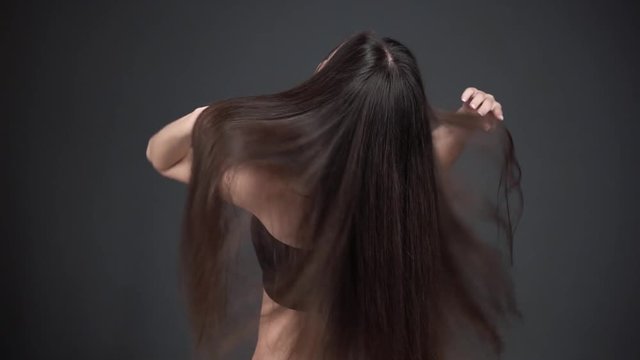 straight dark hair of a woman. Shine health and beauty of hair.