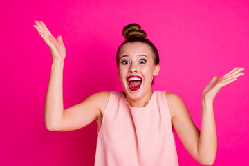 Portrait impressed cute charming lovely youth scream shout raise hands palm reaction wonder ecstatic dressed top-knot modern glamorous feminine clothing isolated pink vibrant background