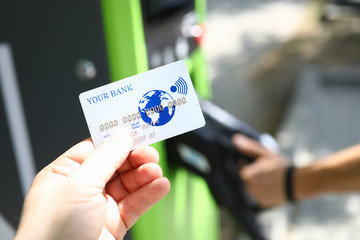 Male hand hold white plastic credit card