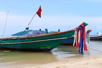 wooden thai traditional fishing boats with nets stand on the beach, samui island Thailand