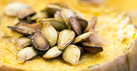 Close-up of roasted yellow pumpkin seeds, healthy eating, vegetarian snack food banner