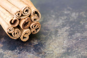 Cinnamon sticks closeup, organic healthy spices, background with copy space