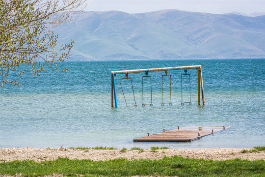 Old broken swing on Coast of clear Sevan Lake in Armenian mountains, Armenia