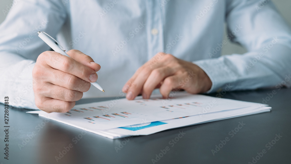 Poster business analysis. cropped shot of man working with graphs and charts. blur background.