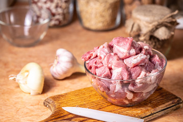 Meat pieces in a glass bowl.