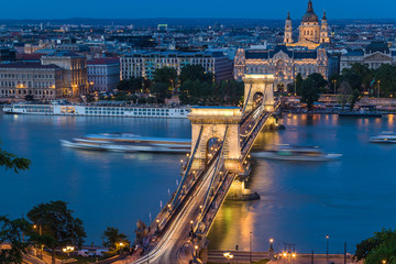 Fototapeta na wymiar Budapest urban scape with the Basilica, Devil's Wheel and the illuminated Chain Bridge across the Danube River by night.