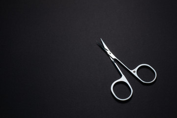 Manicure set of tools made of steel isolated on black background.