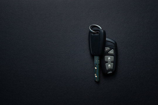 Car keys with remote from car alarm on isolated black background