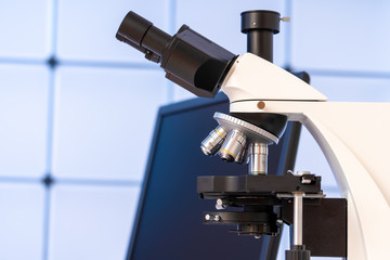 Scientific experiment in microbiological lab. Microscope and test tube