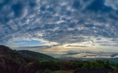 view panorama 180 degrees the eye center of Stratocumulus Clouds shape heart above top hill with cloudy sky background, sunrise at Doi Inthanon, Chiang Mai, Thailand.