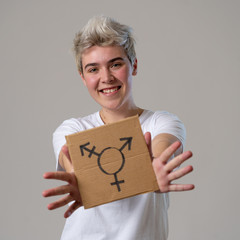 Portrait of happy proud and confident trans teenager man holding transgender symbol