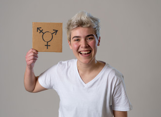 Portrait of happy proud and confident trans teenager man holding transgender symbol