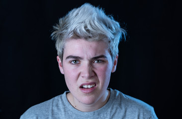 Portrait of a young teenager looking skeptical and displease with something that he dislike