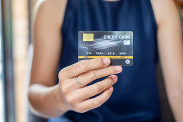 Young casual Business woman holding credit card  for online shopping while making orders in the cafe.business, lifestyle,technology,ecommerce and online payment concept