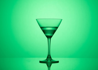 Martini glass on color background