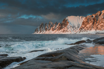 Amazing winter landscape of the ocean with big waves washing the rocks on the Lofoten Islands