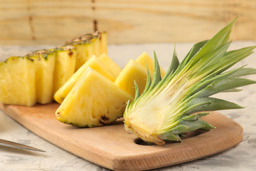 Fresh ripe pineapple halves and pineapple slices on a natural wooden background. summer. fruits.