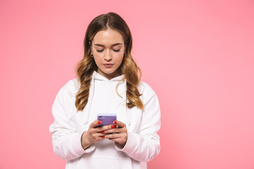 Calm blonde woman wearing in casual clothes using smartphone